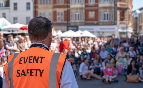Shallow focus of an Event Safety officer seen facing members of